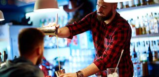 Man falling off his stool in a bar Jokes Times